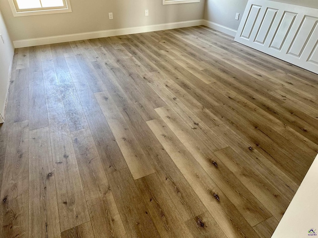 interior space featuring baseboards and wood finished floors