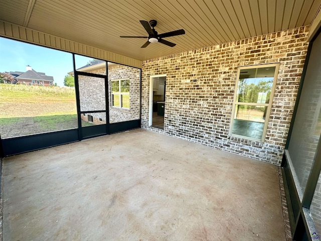 unfurnished sunroom with a ceiling fan