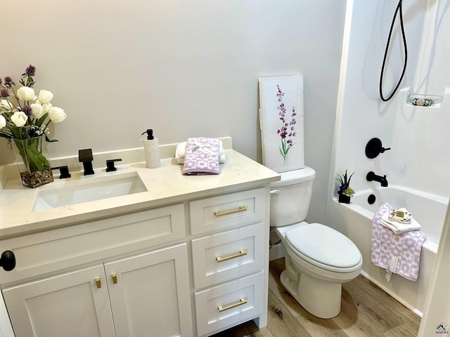 84 Camden Way, Hawkinsville, GA 31036 - bathroom with toilet, wood finished floors, vanity, and bathtub / shower combination
