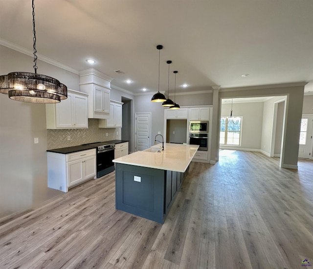 kitchen featuring light wood-type flooring, ornamental molding, decorative backsplash, and stainless steel appliances