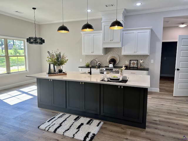 84 Camden Way, Hawkinsville, GA 31036 - kitchen featuring baseboards, white cabinets, a sink, decorative backsplash, and crown molding