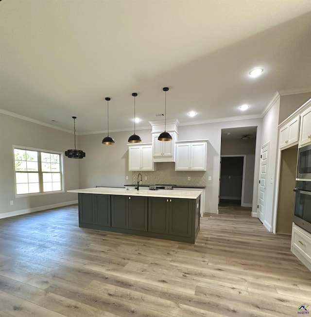 kitchen with baseboards, light wood-style flooring, white cabinetry, and oven