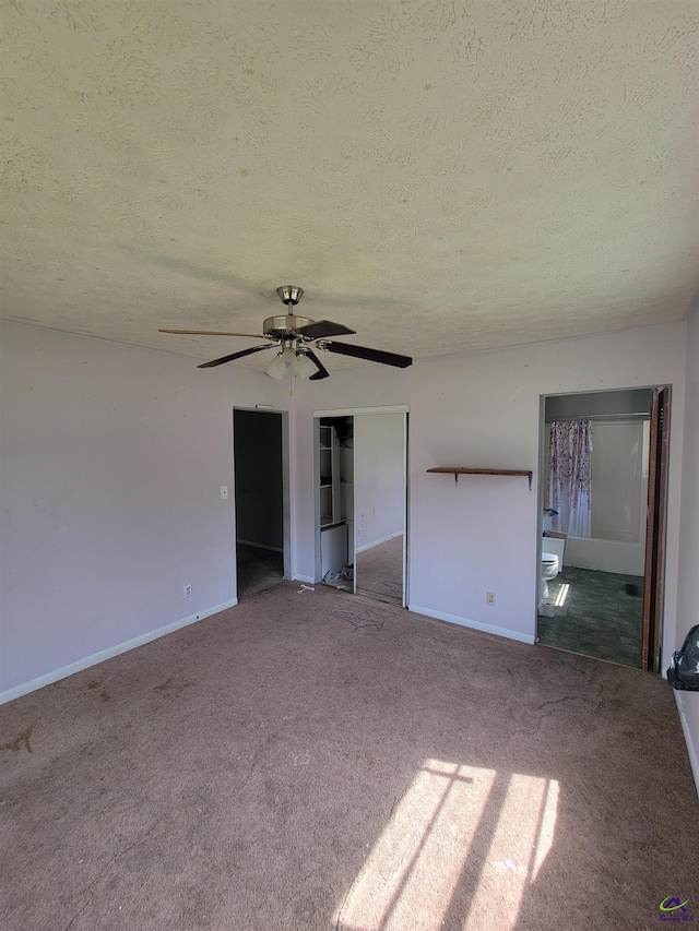 unfurnished bedroom with a closet, baseboards, carpet flooring, and a textured ceiling