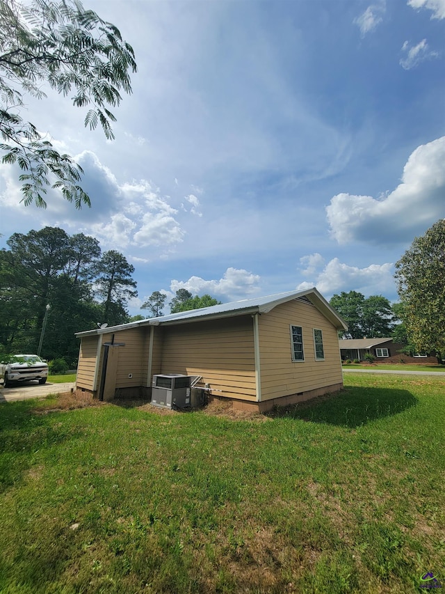 view of home's exterior featuring a lawn and crawl space