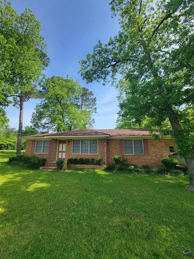 ranch-style home with a front lawn and brick siding