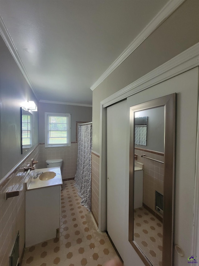 bathroom with vanity, tile patterned floors, a wainscoted wall, tile walls, and a shower with curtain