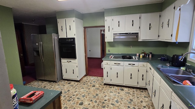 kitchen featuring dark countertops, white cabinetry, under cabinet range hood, a sink, and black appliances