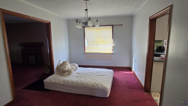 bedroom featuring crown molding, a textured ceiling, carpet, and a notable chandelier