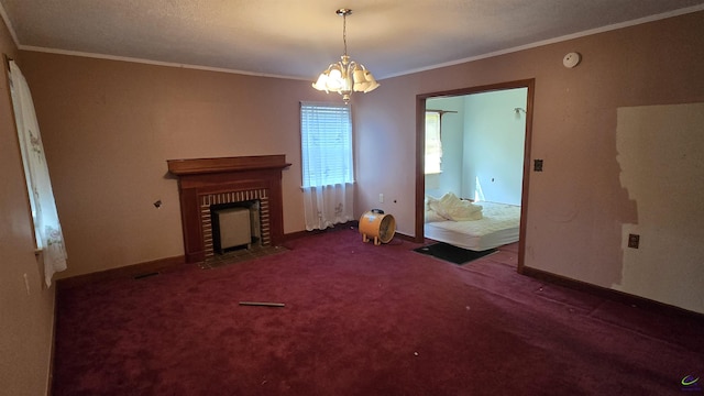 unfurnished living room with crown molding, an inviting chandelier, a brick fireplace, baseboards, and carpet flooring