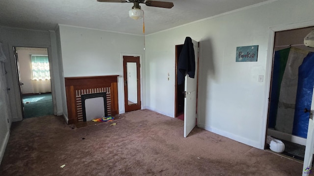 unfurnished living room featuring carpet flooring, crown molding, a brick fireplace, a ceiling fan, and baseboards