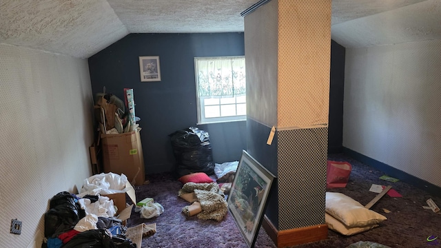 carpeted bedroom featuring vaulted ceiling and a textured ceiling