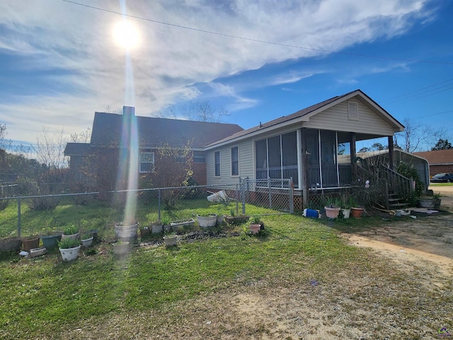 back of property with a sunroom and fence