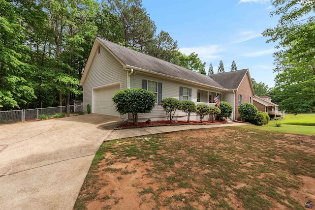 ranch-style house featuring a garage, fence, a shingled roof, and concrete driveway