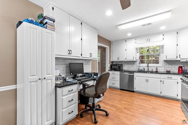 office space featuring a ceiling fan, visible vents, a sink, recessed lighting, and light wood-style flooring