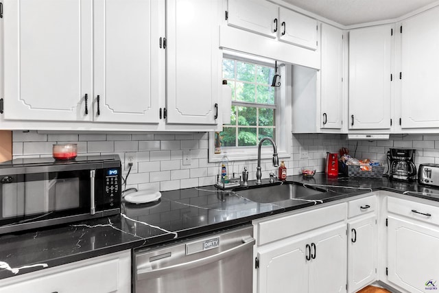kitchen featuring white cabinets and dishwasher