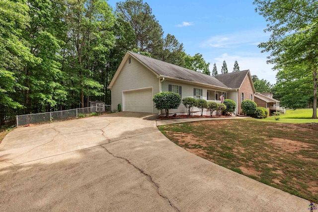 single story home with fence, an attached garage, and concrete driveway