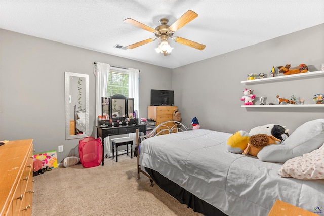 carpeted bedroom featuring visible vents and a ceiling fan