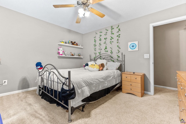 carpeted bedroom with baseboards and ceiling fan