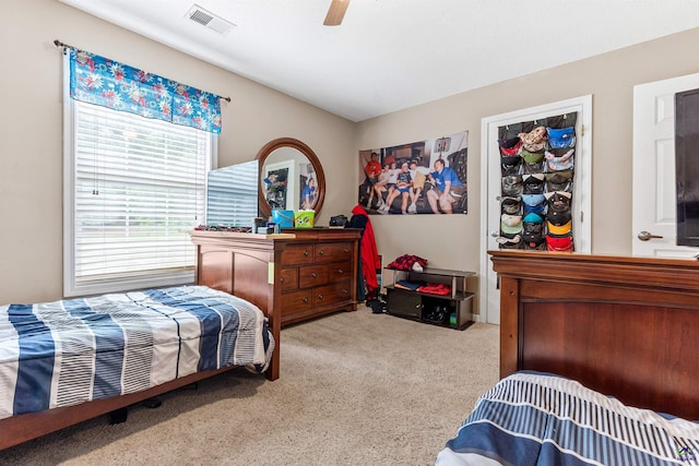 bedroom with a ceiling fan, carpet flooring, and visible vents