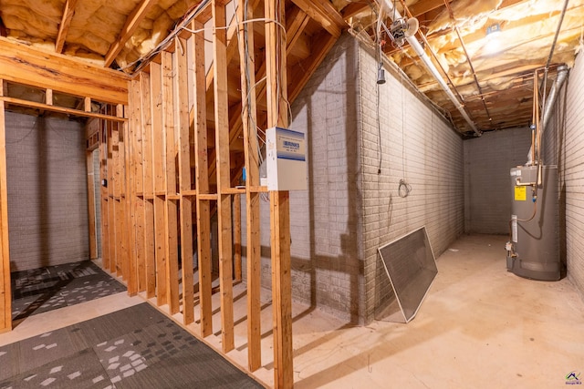unfinished basement with water heater and brick wall