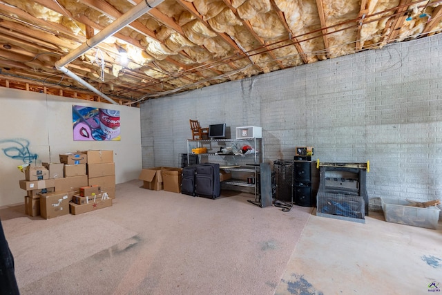 unfinished basement featuring a wood stove