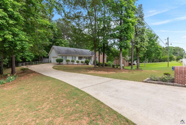 ranch-style house with fence, a garage, a front yard, concrete driveway, and covered porch