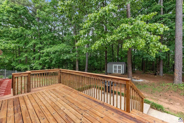 wooden deck featuring a storage unit and an outdoor structure