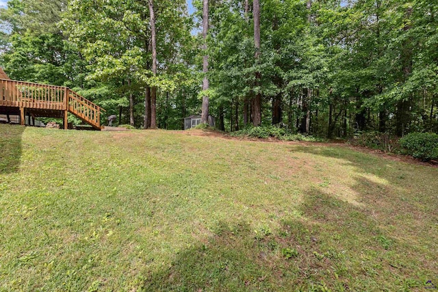 view of yard featuring stairs and a wooden deck