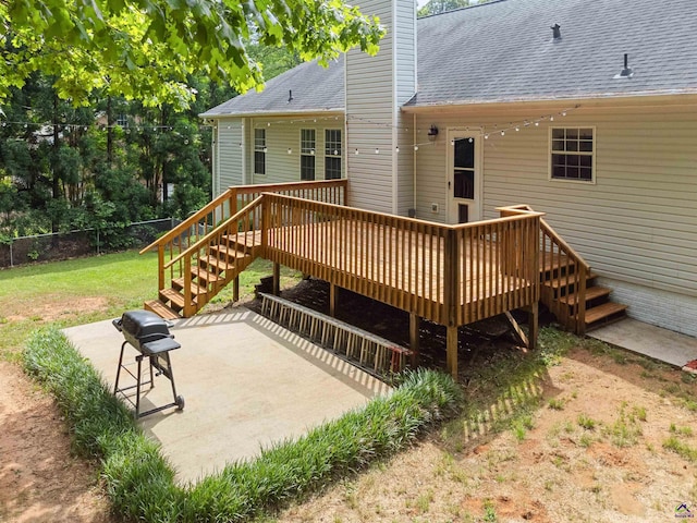 wooden deck with a patio area, fence, a yard, and stairway