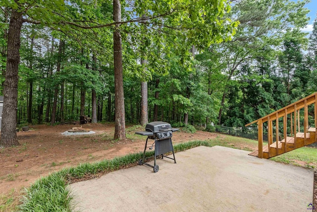 view of patio featuring fence and a grill