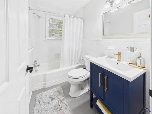 bathroom with vanity, wainscoting, toilet, tile walls, and shower / bath combo