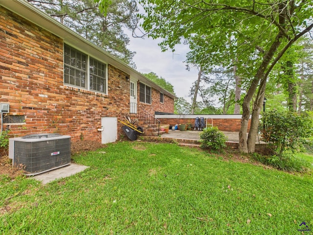 view of yard featuring central AC unit and a patio area