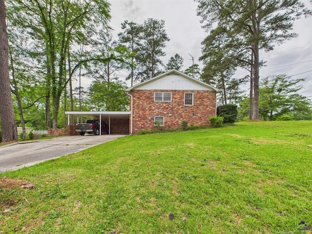 view of home's exterior featuring brick siding, a yard, driveway, and an attached carport