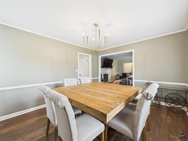dining area featuring baseboards, ornamental molding, dark wood-style flooring, and a notable chandelier