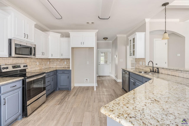 kitchen with white cabinets, stainless steel appliances, and a sink