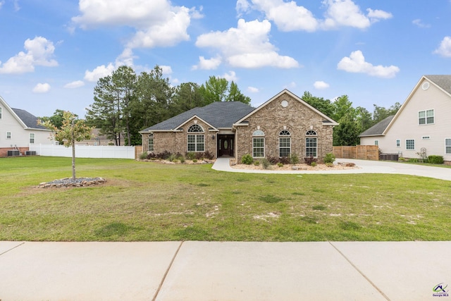 view of front of property with fence, central AC, a front lawn, and brick siding