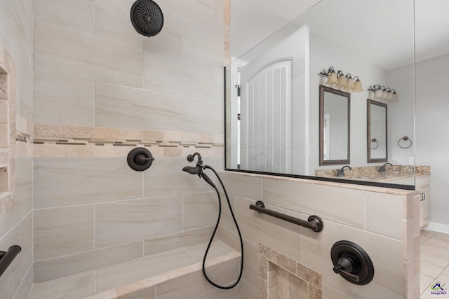 bathroom featuring tile patterned floors and tiled shower