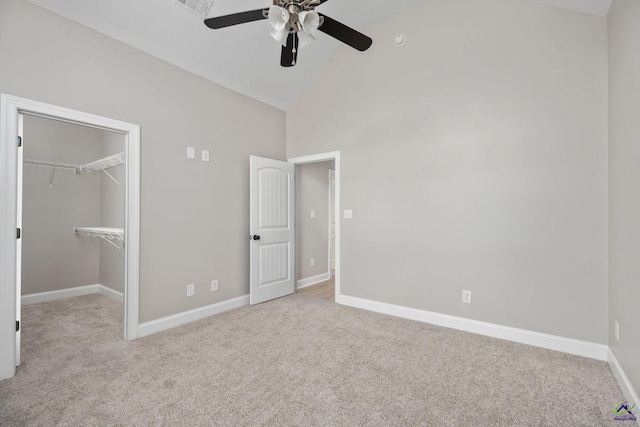 unfurnished bedroom with baseboards, carpet flooring, and high vaulted ceiling
