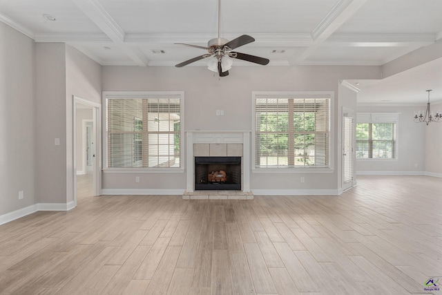 unfurnished living room with beam ceiling, a fireplace, coffered ceiling, light wood-style flooring, and ceiling fan with notable chandelier