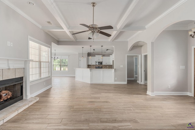 unfurnished living room with ceiling fan, visible vents, light wood finished floors, and a fireplace