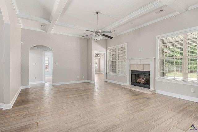 unfurnished living room with ceiling fan, arched walkways, a healthy amount of sunlight, visible vents, and coffered ceiling