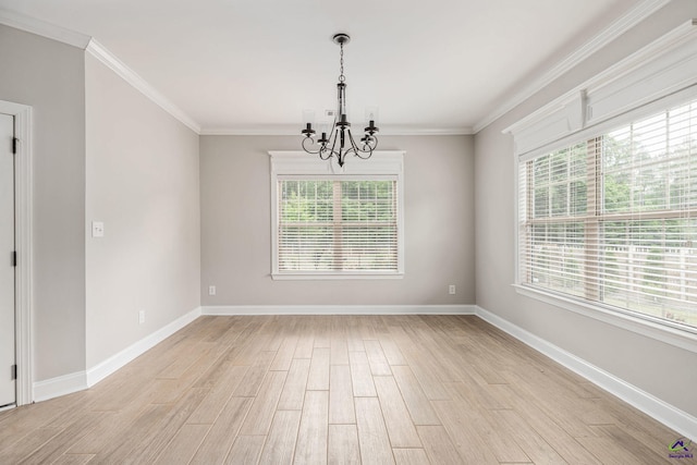 spare room featuring baseboards, a notable chandelier, ornamental molding, and light wood-style floors
