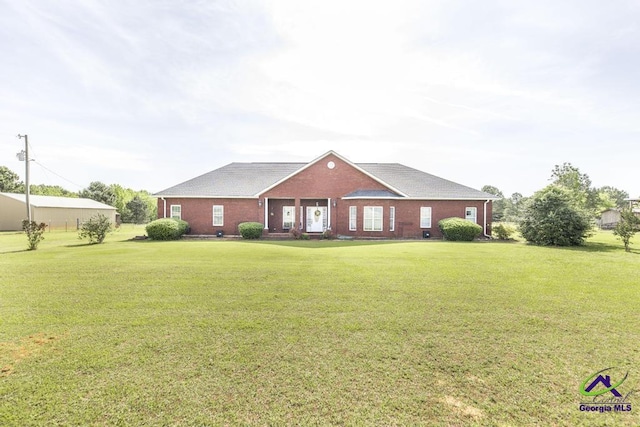 view of front of home featuring brick siding and a front yard