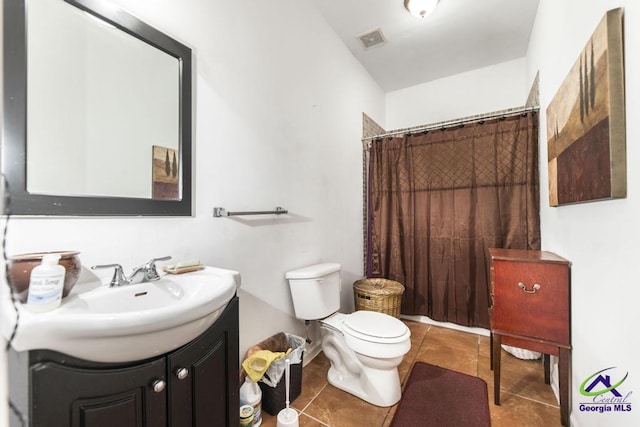 bathroom with tile patterned flooring, vanity, toilet, curtained shower, and visible vents