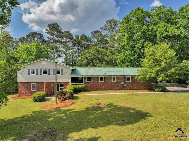 161 Walnut Ridge Dr, Macon, GA 31211 - tri-level home featuring a front yard and brick siding