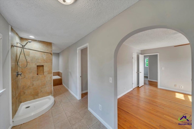 161 Walnut Ridge Dr, Macon, GA 31211 - bathroom with tiled shower, baseboards, tile patterned flooring, and a textured ceiling