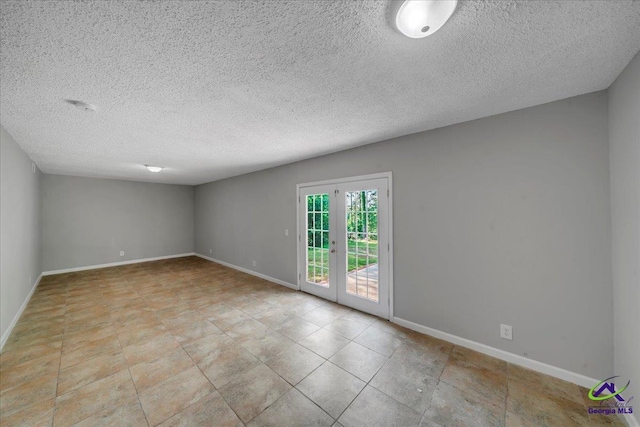 161 Walnut Ridge Dr, Macon, GA 31211 - tiled empty room featuring baseboards and a textured ceiling