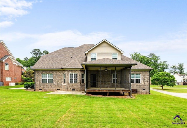 rear view of property with a lawn, a patio area, brick siding, and crawl space