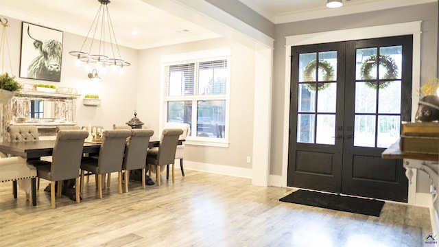dining room featuring french doors, crown molding, and plenty of natural light