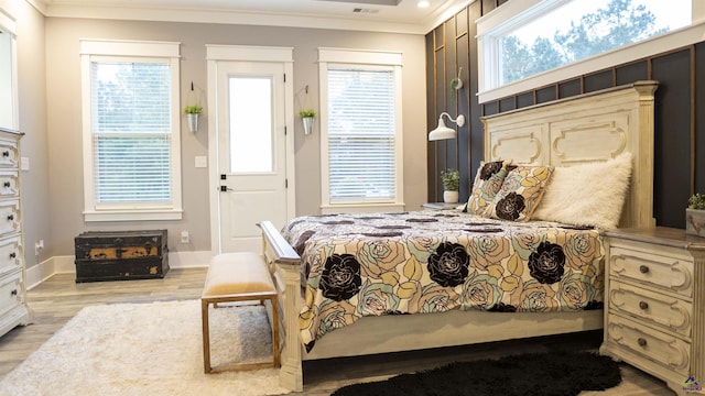 bedroom featuring baseboards, recessed lighting, crown molding, and wood finished floors